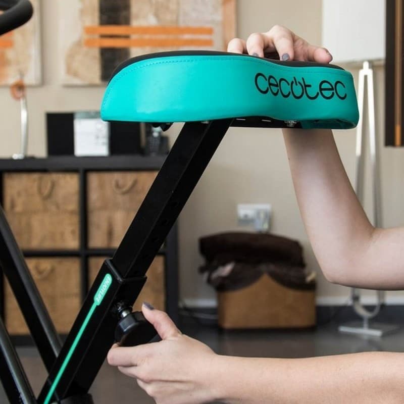 Assento acolchoado verde com ajuste de altura por manípulo, suporte robusto em metal preto da Bicicleta de exercício dobrável X-Bike cecotec