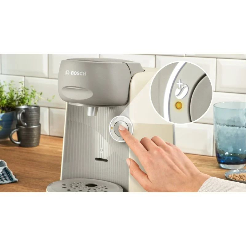 Bosch Tassimo Finesse TAS16B7, cafetera de cápsulas negra y beige con panel frontal estriado, boquilla central, botón circular iluminado y bandeja antigoteo - Ítem1