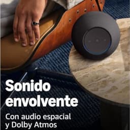 Amazon Echo Studio Grafito cilíndrico en tela oscura, anillo LED azul y panel táctil superior; diseño elegante para sonido envolvente con Dolby Atmos