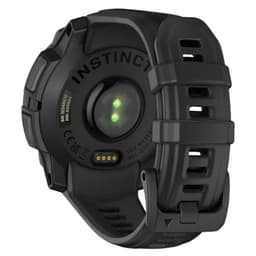 Parte traseira do Garmin Instinct 3 45 mm Solar Preto com pulseira de silicone preta, sensor óptico verde, carregamento por pinos e fecho robusto ajustável