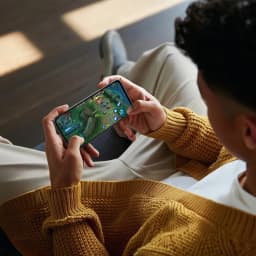 Oppo A6X 128GB Negro Lila con pantalla de 6.75 pulgadas, bordes delgados y diseño elegante, mostrado en uso para juegos en modo horizontal