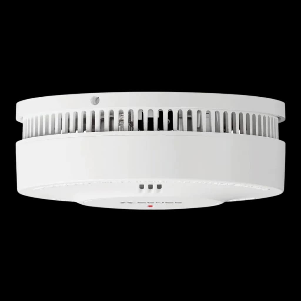 Detector de Humo blanco, circular y compacto, con rejillas laterales de ventilación, botón de prueba frontal y LED indicador en la base