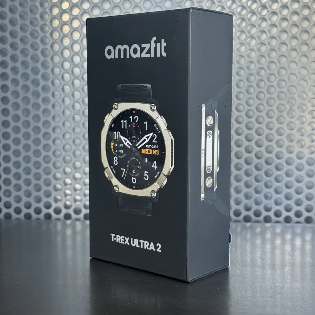 Caixa do Amazfit T-Rex Ultra 2 Magma Preto com relógio exibido: ecrã AMOLED 1,5 pol, moldura robusta metálica, botões laterais e pulseira preta