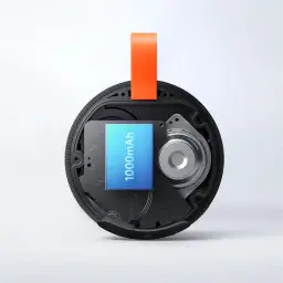 Module interne de l’enceinte: batterie 1000 mAh visible, haut-parleur circulaire, circuits exposés, boîtier rond noir avec sangle orange robuste IP66