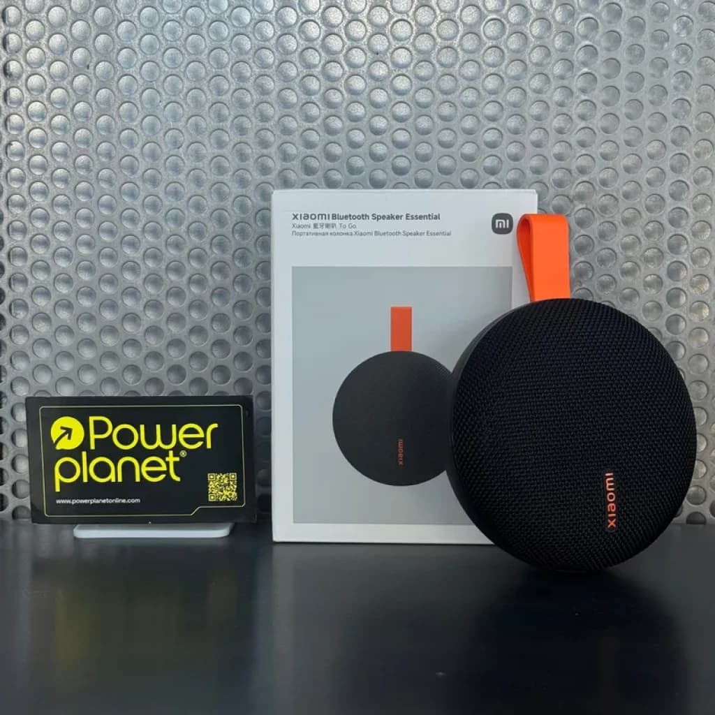Enceinte portable noire Xiaomi Bluetooth Speaker Essential 5W, forme ronde, grille maillée, sangle orange vive, boîtier et logo Xiaomi visibles en