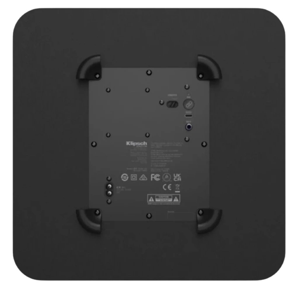 Klipsch Flexus Sub 100 80 W en negro mate, panel frontal liso con logotipo circular plateado en la base, diseño compacto y minimalista - Ítem3