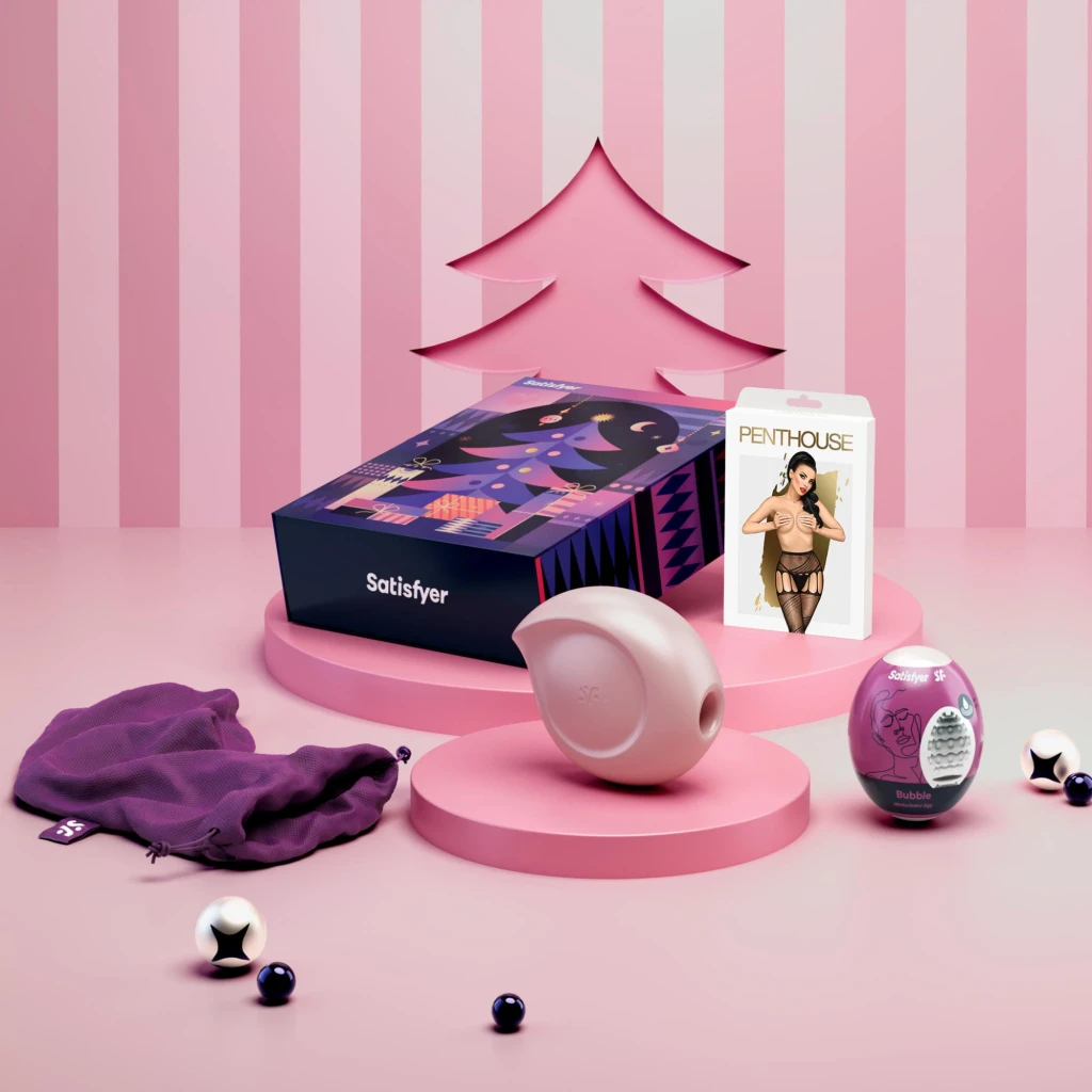 Caja Satisfyer Love Box estilo calendario de adviento en tonos morado y rosa, con árbol navideño ilustrado y compartimentos numerados 1, 2, 3, 4 - Ítem1