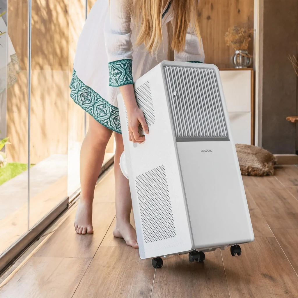 Aire acondicionado portátil blanco con rejilla frontal vertical, panel superior táctil, asa lateral y control por app y mando; flujo de aire azul visible - Ítem5
