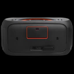 Dos de l’enceinte noire avec poignée intégrée, contour orange autour du compartiment, grille texturée, ports d’alimentation et cache caoutchouc