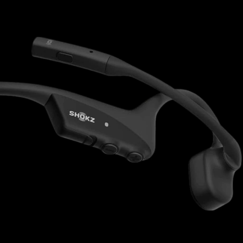 Auriculares Shokz Opencomm 2 2025 negros, diseño de conducción ósea con banda trasera flexible, micrófono con brazo, botones laterales y puerto de carga