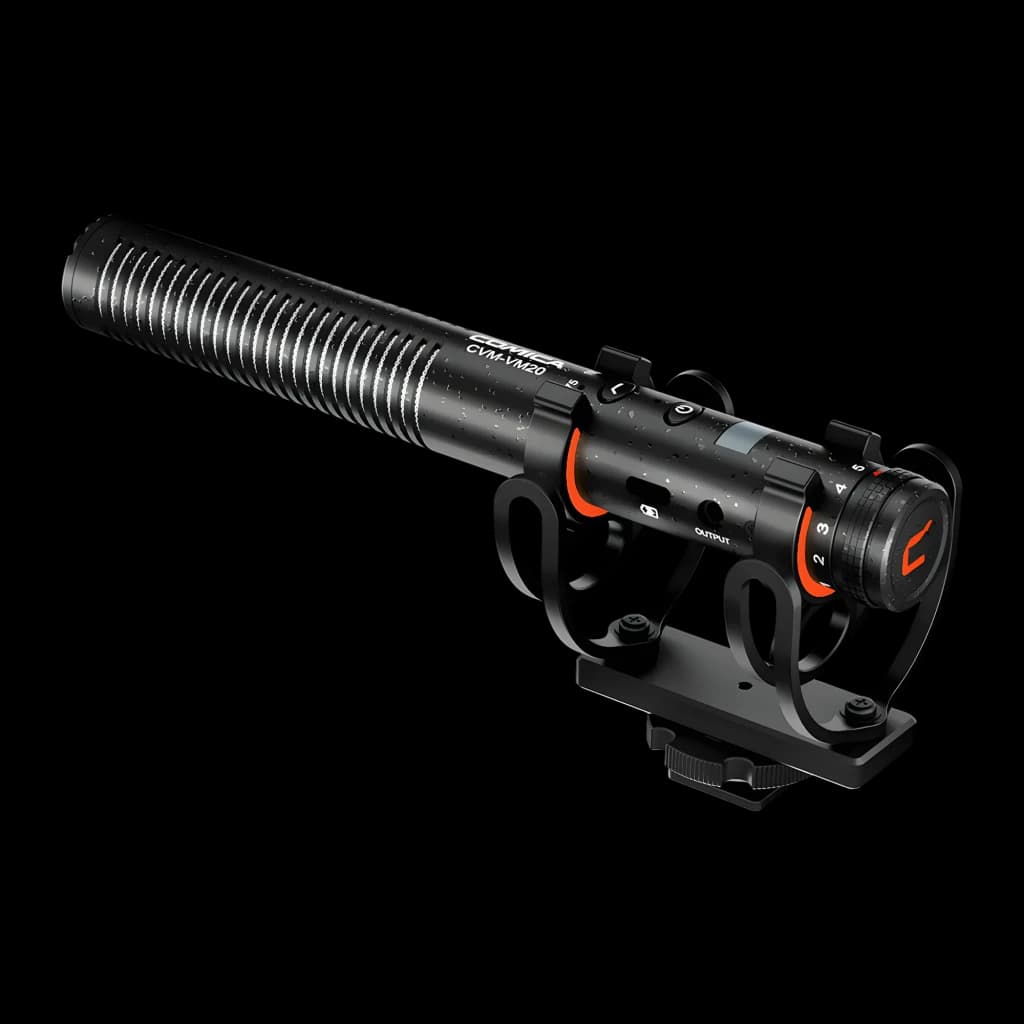 Microphone Comica CVM-VM20 shotgun supercardioïde noir, corps allongé à fentes, bagues orange, monture anti‑choc et griffe pour appareil photo
