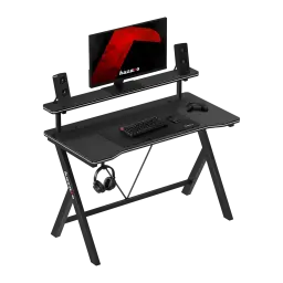 Huzaro Mesa gaming Hero 1.9 Negro, vista en ángulo: superficie carbono, estante elevado con monitor y altavoces, gancho
