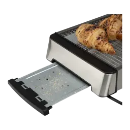 Orbegozo Grille-pain TO 2030 600W Argent, détail: tiroir ramasse-miettes sorti avec miettes et croissants grillés sur la