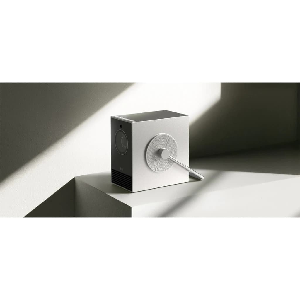 LG PU600U projecteur 4K UHD 600 lumens argenté, vue latérale: design cubique avec haut-parleur circulaire et télécommande