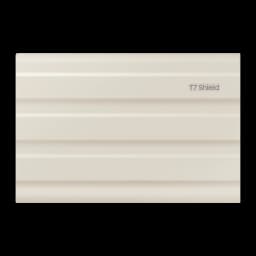 Samsung T7 Shield 2TB Beige, vue arrière à plat: surface rainurée beige avec logo T7 Shield dans le coin
