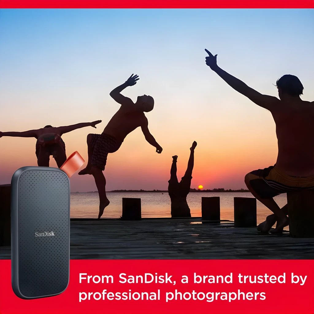 SanDisk SSD Portable V2 2TB preto, vista frontal: superfície texturizada com pontos, logo e alça laranja - Item6