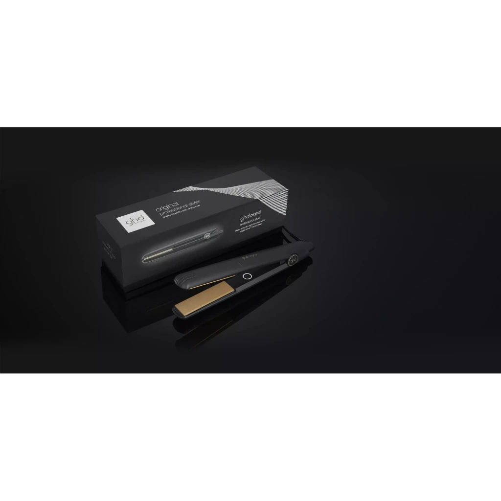 ghd Original Styler preto, vista com caixa: chapinha preta com placas douradas ao lado da embalagem preta em superfície