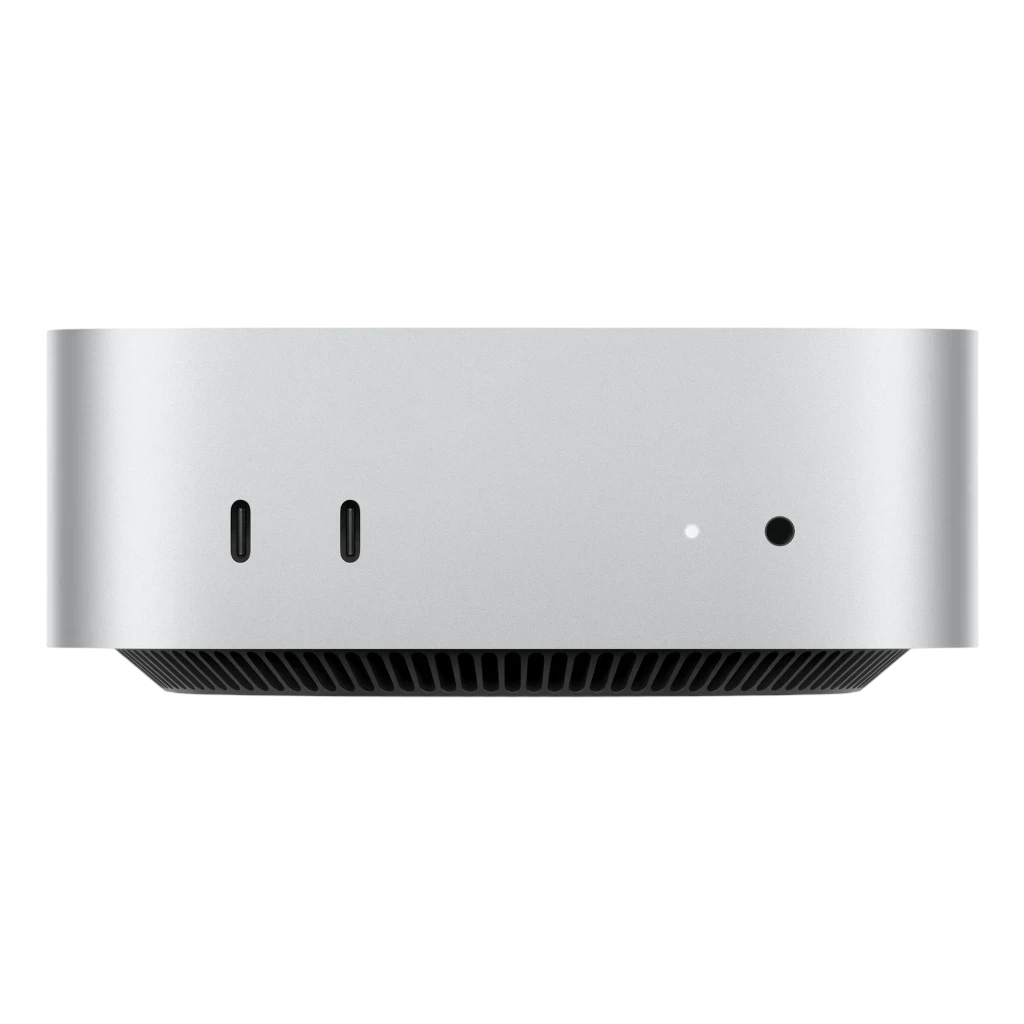Apple Mac mini M6 plata compacto, frontal con 2 puertos USB‑C, LED indicador y jack 3.5 mm; chasis metálico con rejilla inferior de ventilación