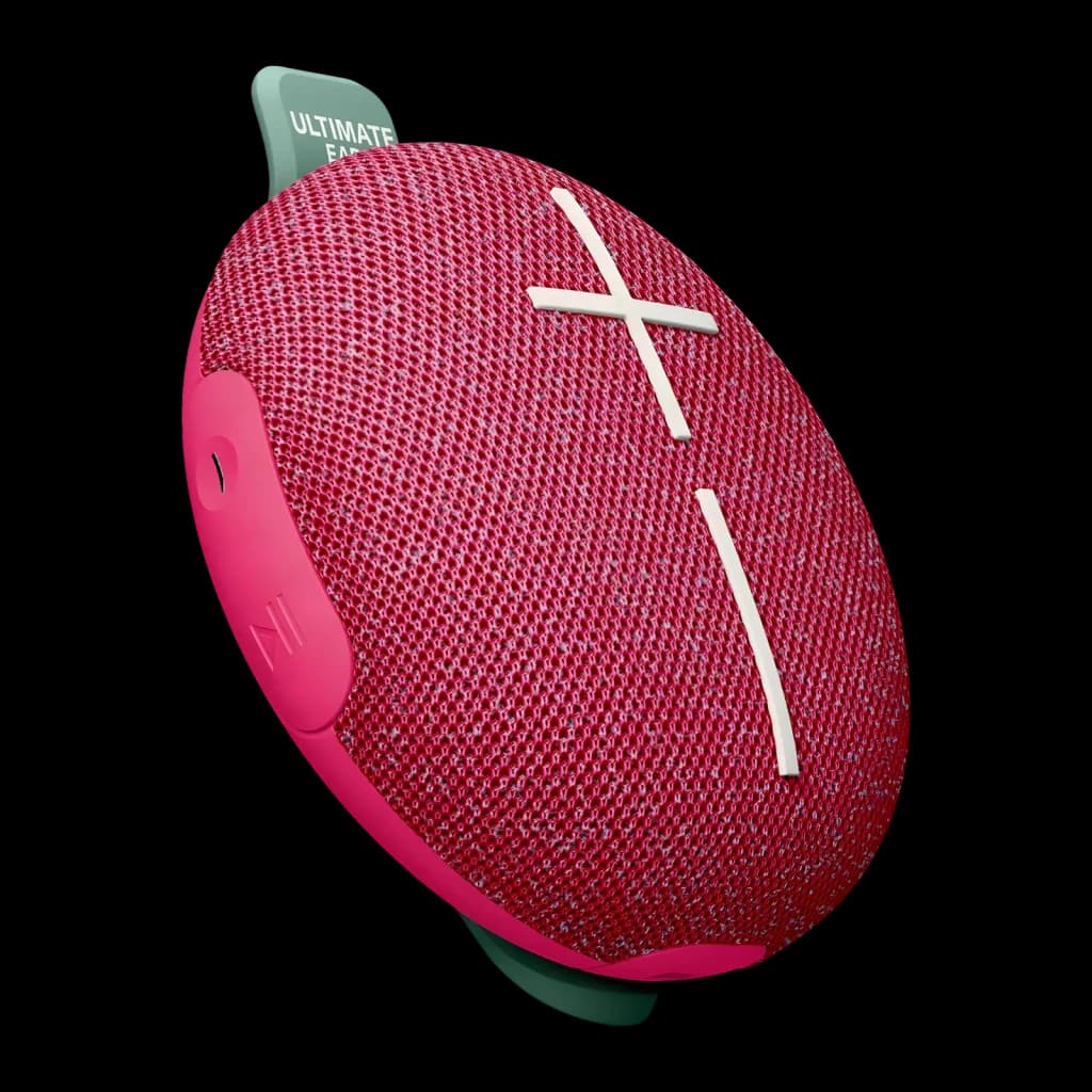 Altavoz portátil Ultimate Ears Miniroll IP67 12h Bluetooth Rosa, vista frontal en ángulo: rejilla rosa con cruz blanca y asa