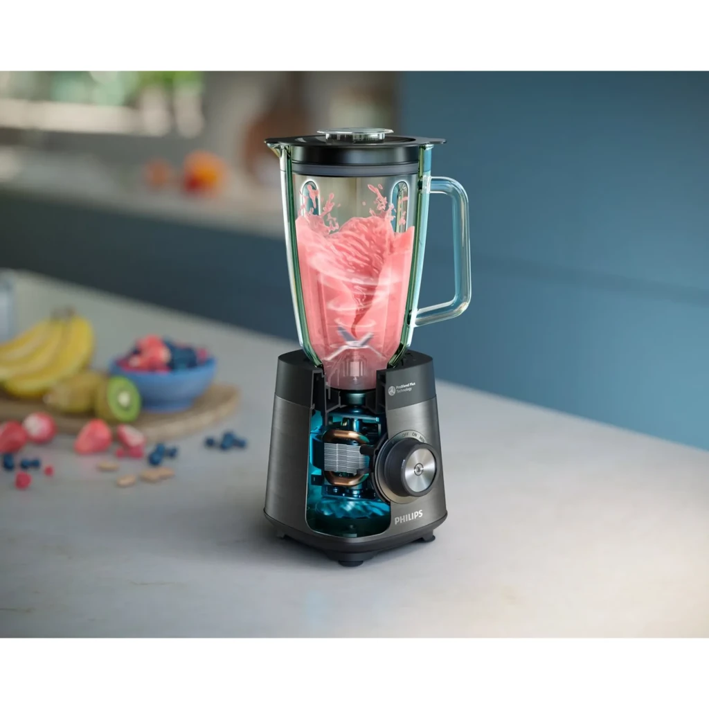Batidora de vaso Philips Series 5000 2L Picahielos 1200W Negro HR3040/00, en uso: vaso de cristal triturando smoothie rosa