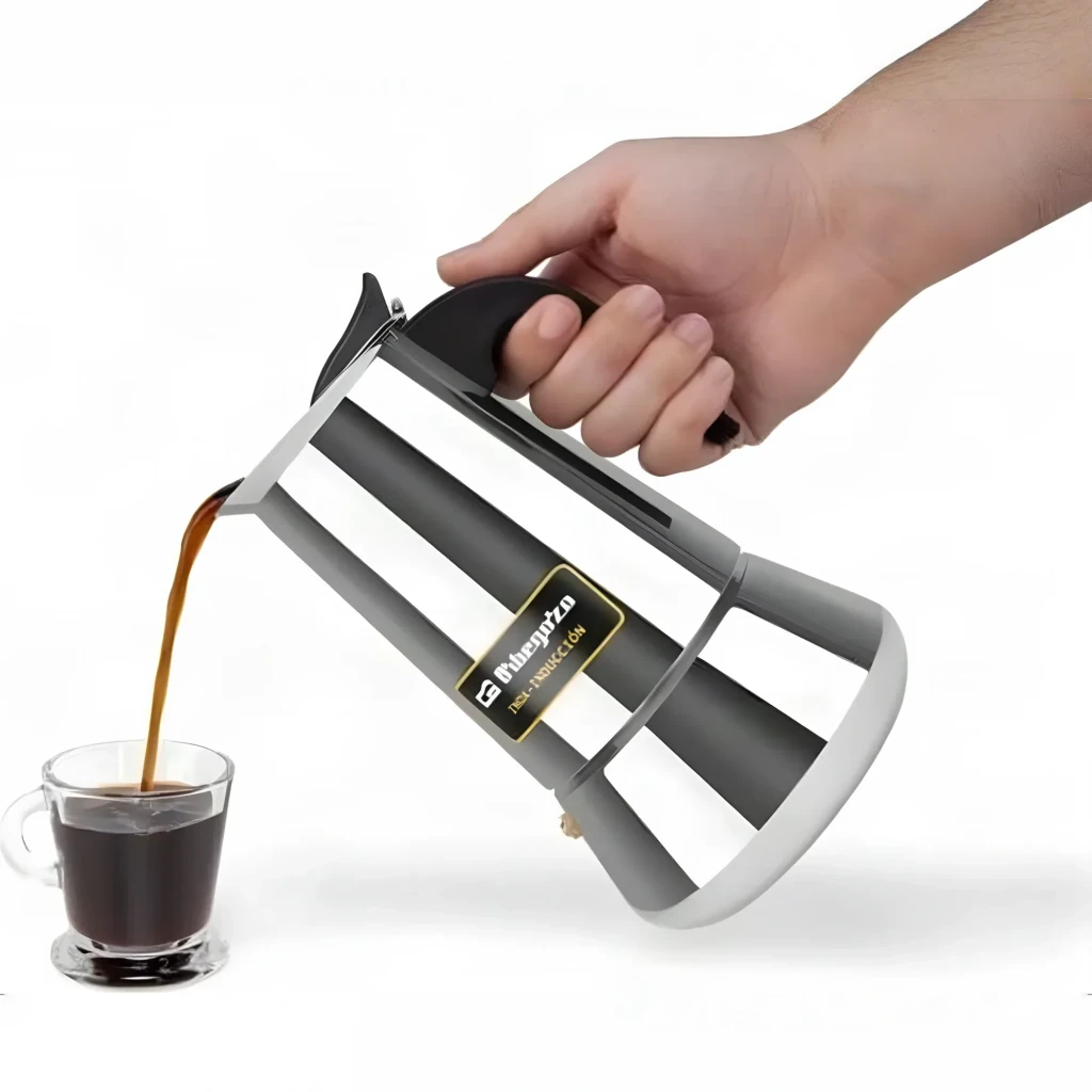 Cafetière italienne Orbegozo 9 tasses Noir/Acier inoxydable KFI 960, en usage: main tenant la poignée noire versant du café
