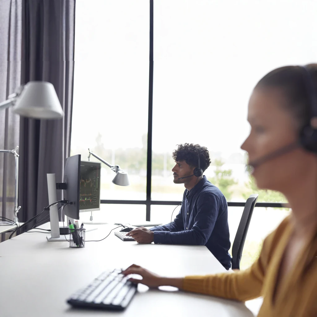 Casque Poly EncorePro 310 Réduction de bruit Arceau USB-C Noir, en utilisation: deux agents avec casques travaillant devant