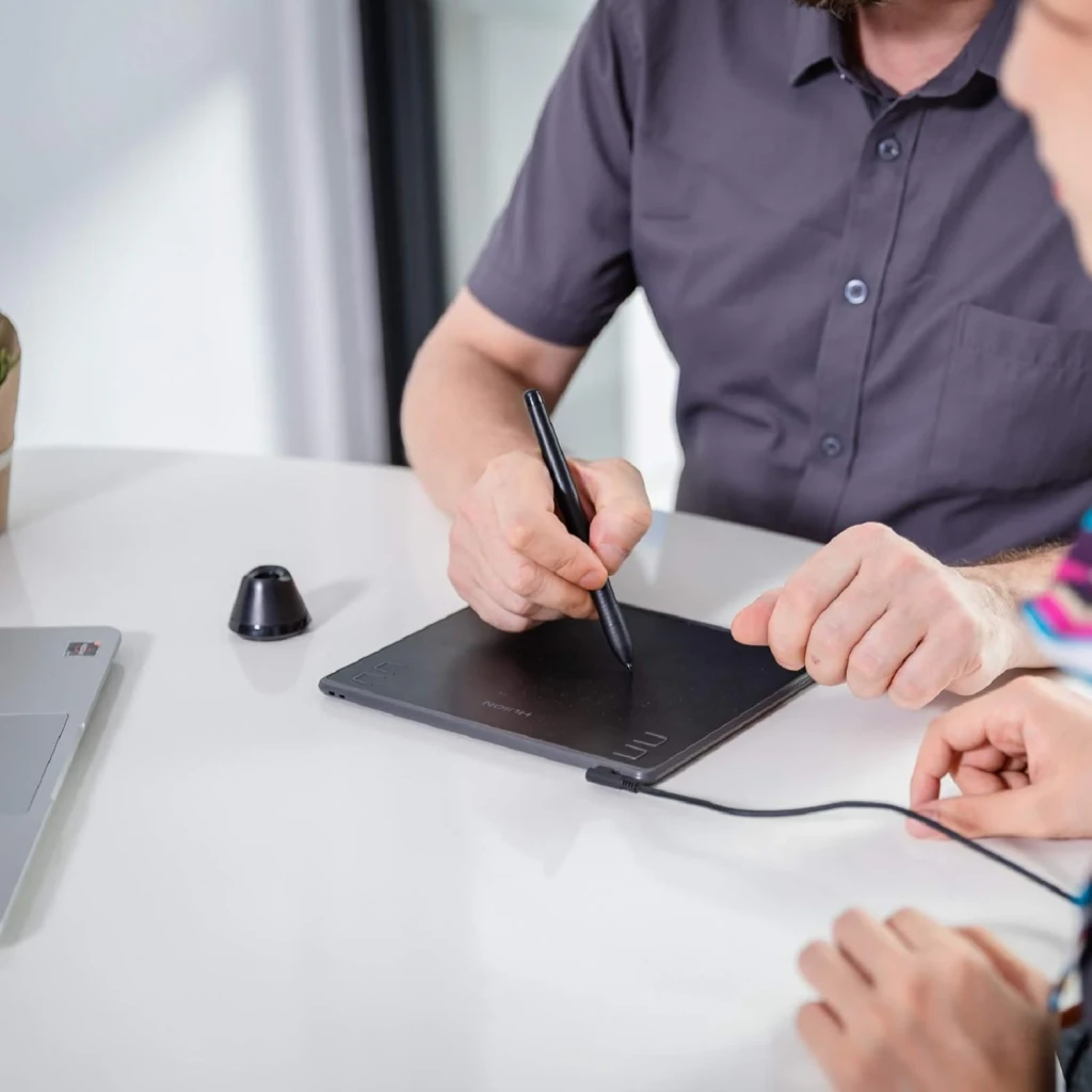 Tableta Gráfica Huion H430P Negro 4096 Niveles de Presión Sin batería, en uso: mano dibujando con lápiz sobre tableta