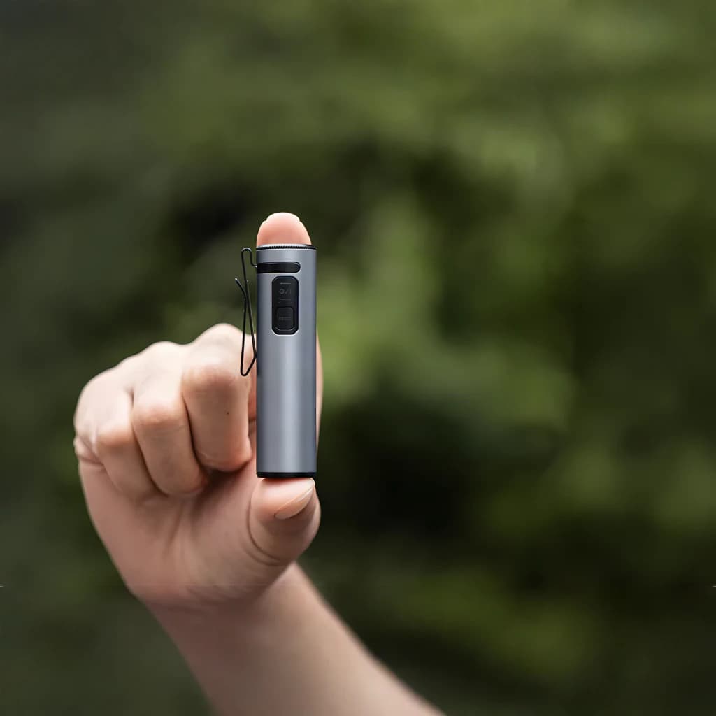 Lanterna LED Flextail Zero 1200 Cinzento USB-C lúmens IP67 até 1 m, em uso: mão segura a lanterna cinzenta compacta