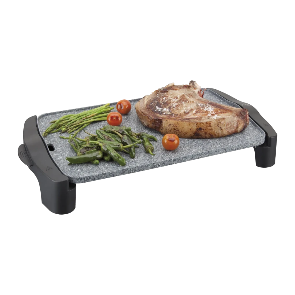 Plancha de asar JATA GR558 2500W Negro/Gris, detalle: superficie de piedra con chuletón, espárragos y tomates cherry