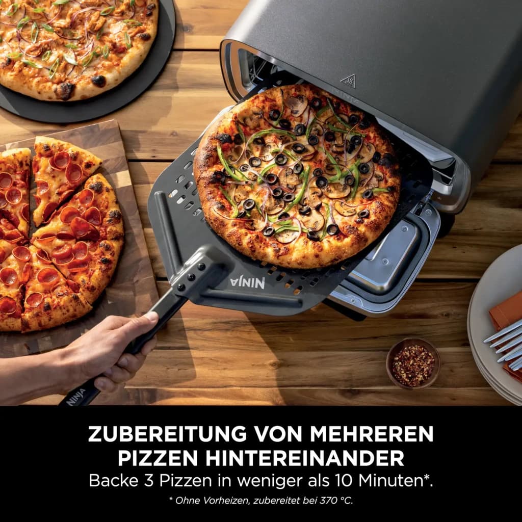 Four à pizza Ninja Artisan 1760W Acier Inoxydable MO201EU, utilisation: pelle Ninja sortant une pizza garnie du four ouvert