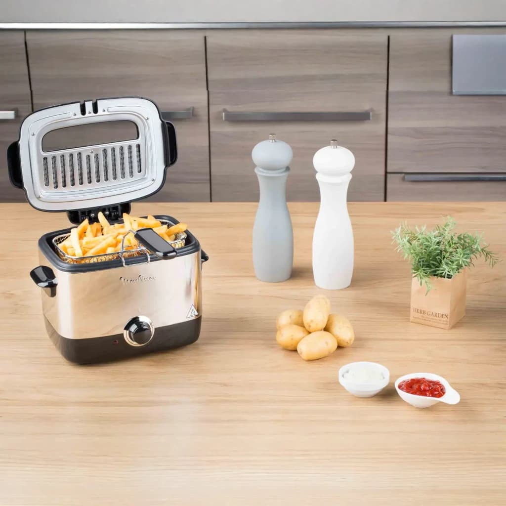 Freidora Moulinex Minifrito 1L 1000W Negro AF220010, en uso: tapa abierta con patatas fritas en la cesta, encimera de cocina