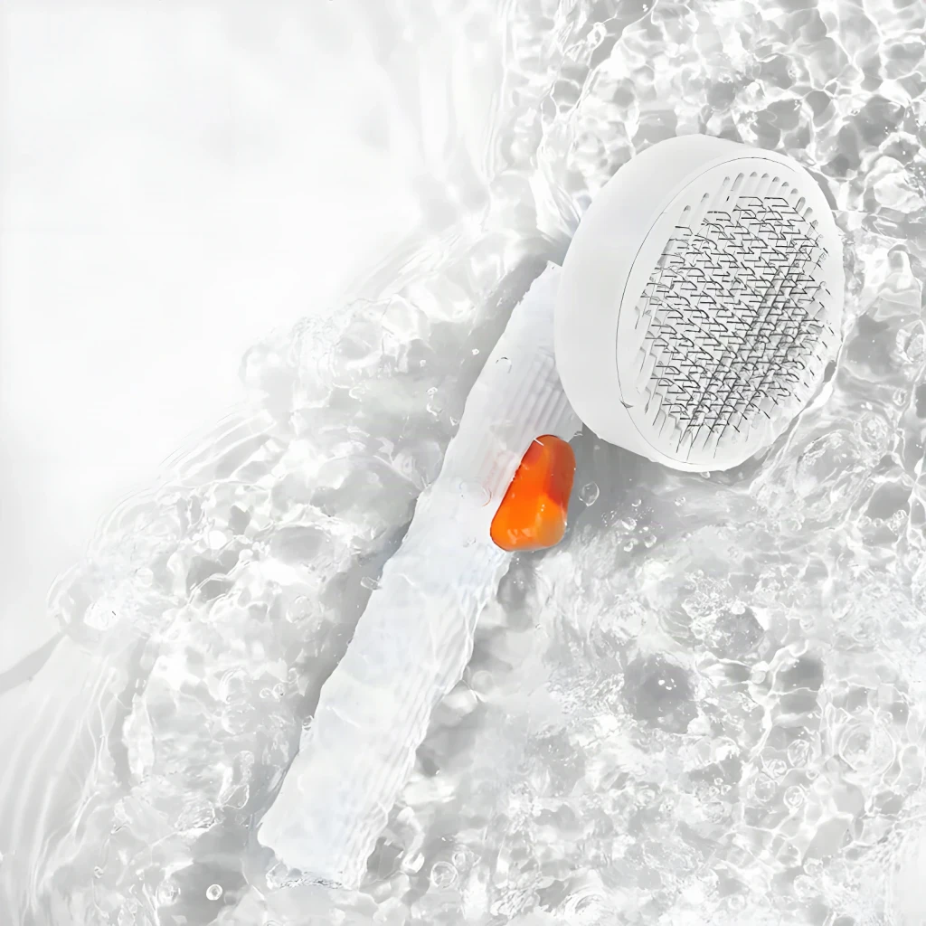 Cepillo de aseo Petkit Grooming Brush 2 Perros y gatos Blanco, vista cenital: sumergido en agua con botón naranja visible