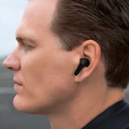 Auriculares JLab Audio JBuds Pods ANC Cancelación de Ruido TWS, uso: earbud negro en oído derecho de hombre, perfil lateral