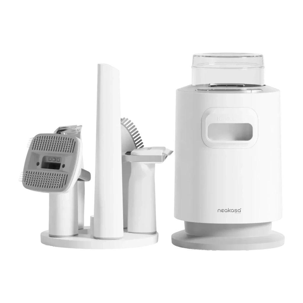 Kit de aseo Neakasa P0 Pro Blanco, vista frontal: unidad aspiradora cilíndrica y soporte con accesorios cepillo y cortadora