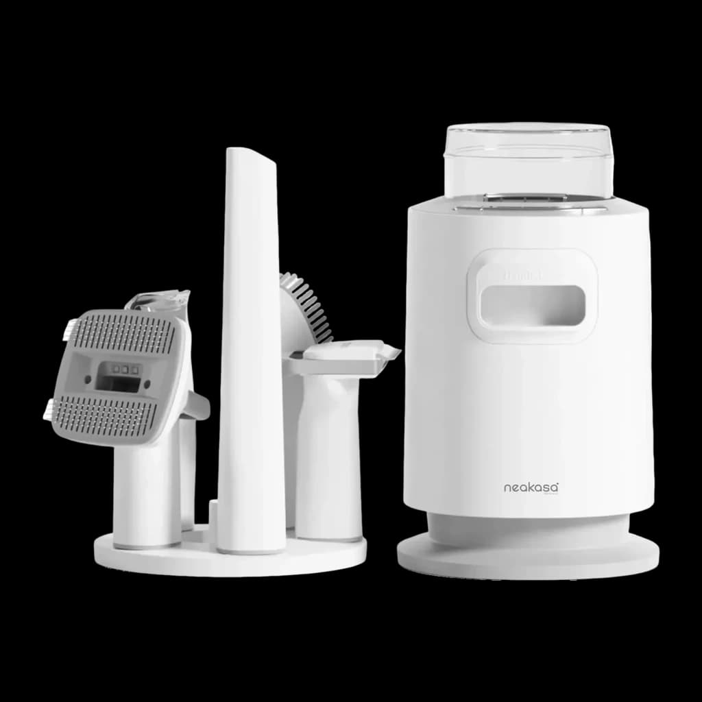 Kit de aseo Neakasa P0 Pro Blanco, vista frontal: unidad aspiradora cilíndrica y soporte con accesorios cepillo y cortadora