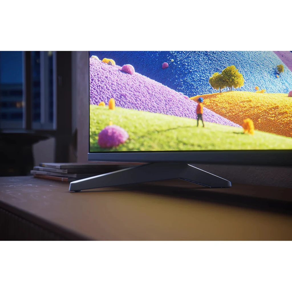 TV Philips 43 pulgadas LED 4K Negro 43PUS7001/12, detalle lateral: base y marco negro con pantalla 4K encendida en salón