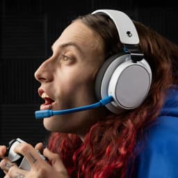 Auriculares Skullcandy SLYR Pro Wireless Gaming PlayStation Inalámbrico Negro/Azul - gamer de perfil con mando PS5