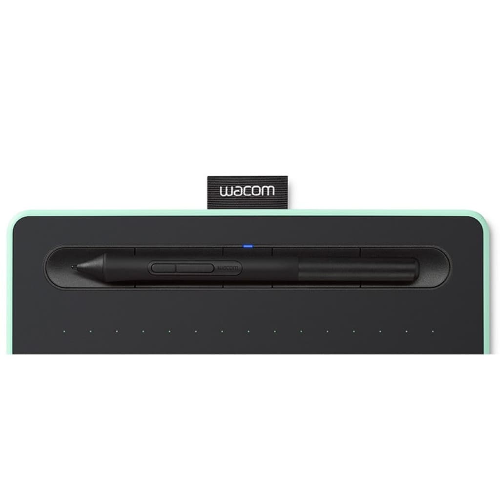 Tablette Wacom Intuos S pistache avec stylet noir rangé dans son logement, surface de dessin pointillée, bord vert menthe, languette Wacom centrale
