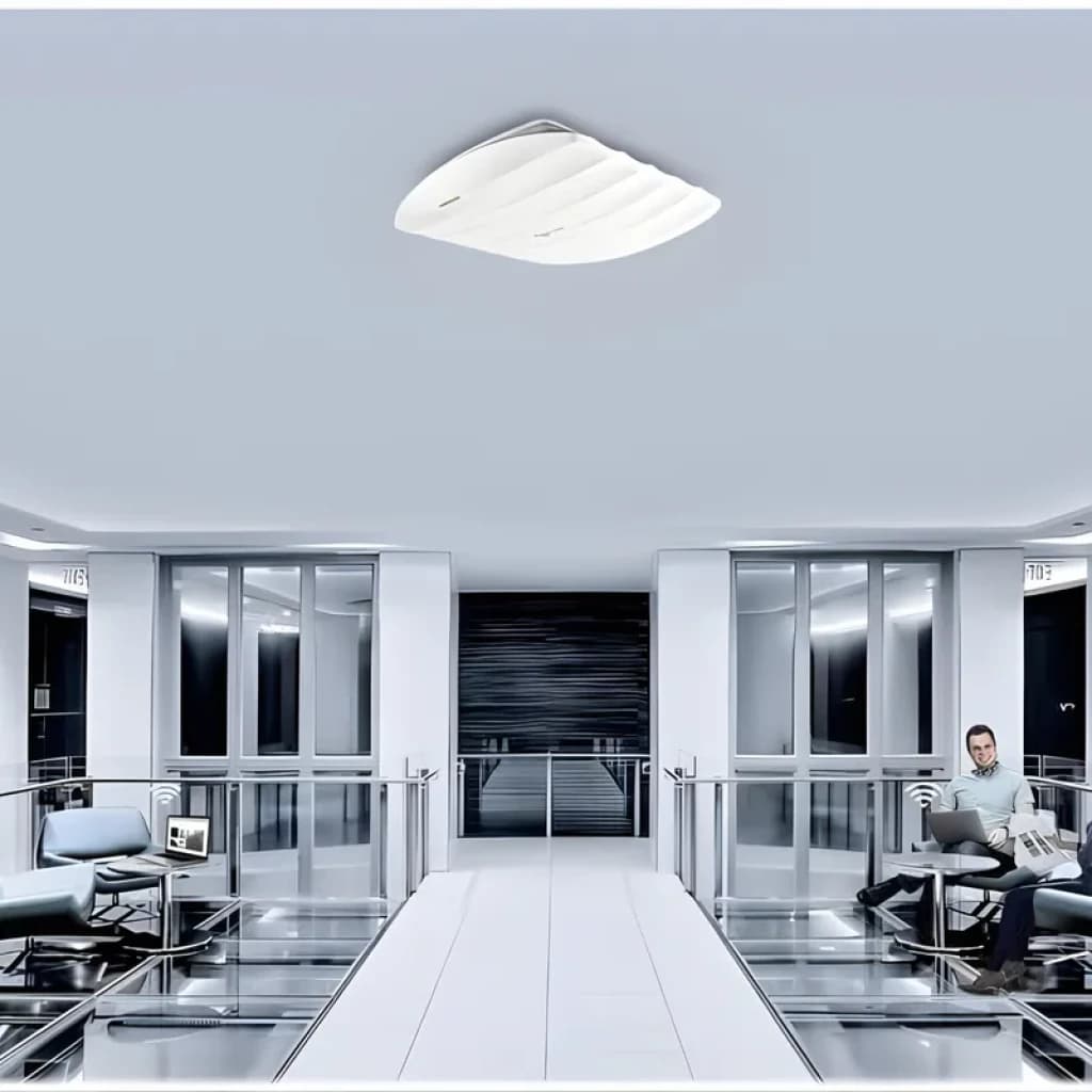 Point d accès TP-Link Omada EAP245 blanc plafond, design ondulé, voyants LED verts, montage discret au centre d un couloir moderne en métal et verre