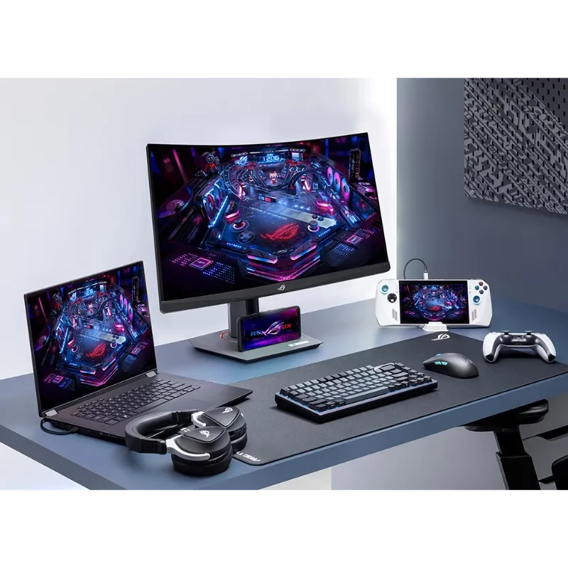 Monitor gamer curvo 27 pol QHD com molduras finas, base ajustável e tela vibrante; exibe mascote ROG em fundo vermelho, ideal para setups de alto desempenho - Item1