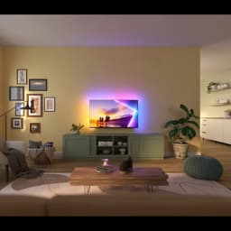 Philips 85PUS8510 85 polegadas 4K QLED com Ambilight, ecrã fino em moldura metálica, luzes LED traseiras coloridas realçando a parede e imagem vibrante