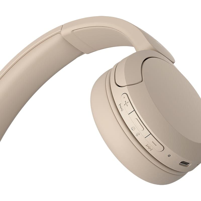 Sony WH-CH520 Creme com conchas arredondadas, arco acolchoado e botões laterais de volume e controle em tom bege fosco, design leve e minimalista