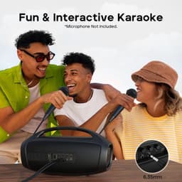 Enceinte portable noire avec poignée, façade LED lumineuse, deux microphones utilisés pour karaoké, ports audio visibles dont prise 6,35 mm, design robuste